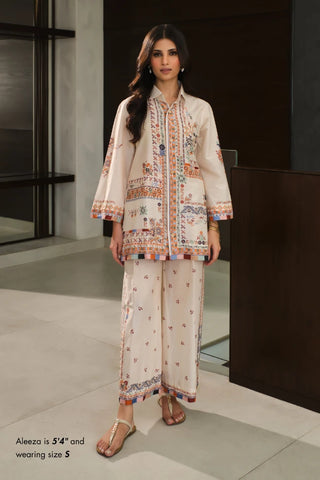 Woman wearing a traditional outfit with floral patterns in an indoor setting