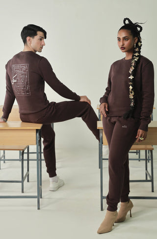 Manto's Unisex Premium Fleece Sanki Brown Sweatshirt featuring Motif with Urdu Calligraphy at the back Paired with Brown Jogger Pants