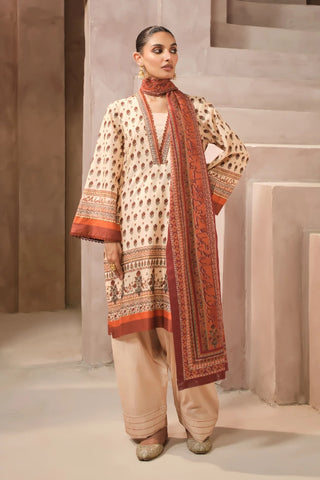 Woman wearing a traditional outfit with a patterned scarf in an indoor setting