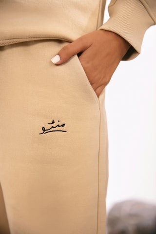 Shopmanto, wear manto, pakistan, women, men, ladies, clothing, urdu, calligraphy, jogger pants, winter wear, karachi, western clothing, manto store, urdu calligraphy clothing, unisex jogger pants, unisex winter wear, hoodies in pakistan, jogger pants for men, jogger pants for women, track pants, track suits, comfort, soft, French vanilla Jogger pants, manto logo embroidery on jogger pants, comfort revolution