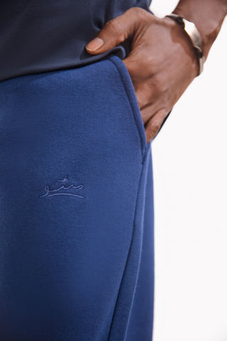 Shopmanto, wear manto, pakistan, women, men, ladies, clothing, urdu, calligraphy, jogger pants, winter wear, karachi, western clothing, manto store, urdu calligraphy clothing, unisex jogger pants, unisex winter wear, hoodies in pakistan, jogger pants for men, jogger pants for women, track pants, track suits, comfort, soft, midnight blue Jogger pants, manto logo embroidery on jogger pants, comfort revolution