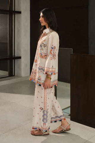 Woman wearing a white embroidered outfit in an indoor setting