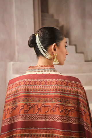 Woman wearing a patterned shawl with Urdu calligraphy