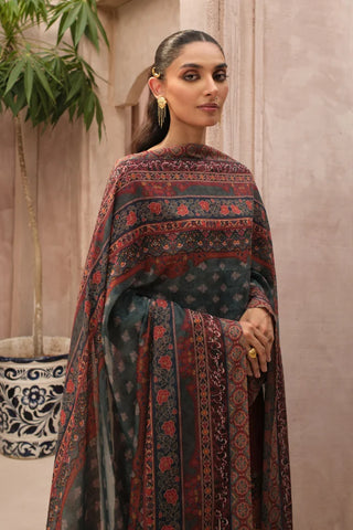 Woman wearing a patterned shawl against a neutral background