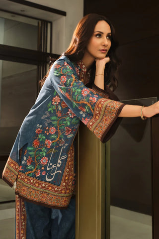 Woman wearing a traditional embroidered outfit in an indoor setting